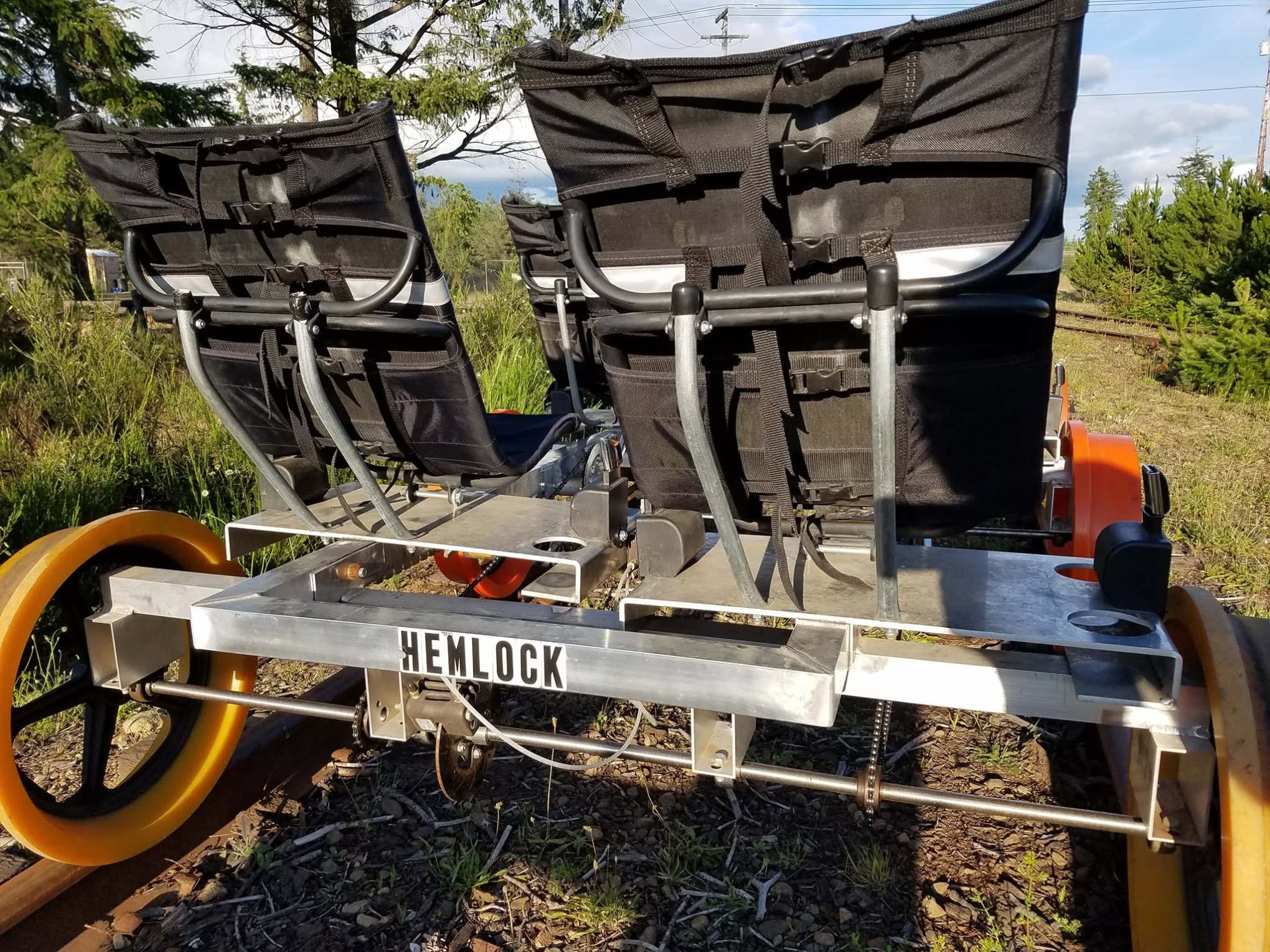 Rear view of a railbike with two seats on railway tracks.